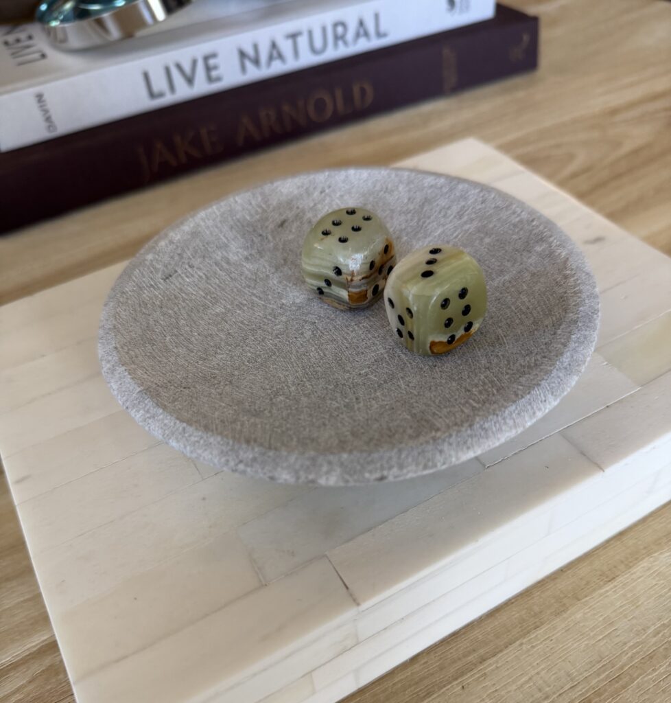 green marble dice in a dish